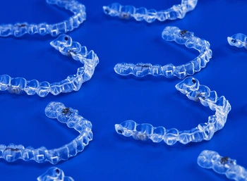 several clear aligner trays in a flat surface